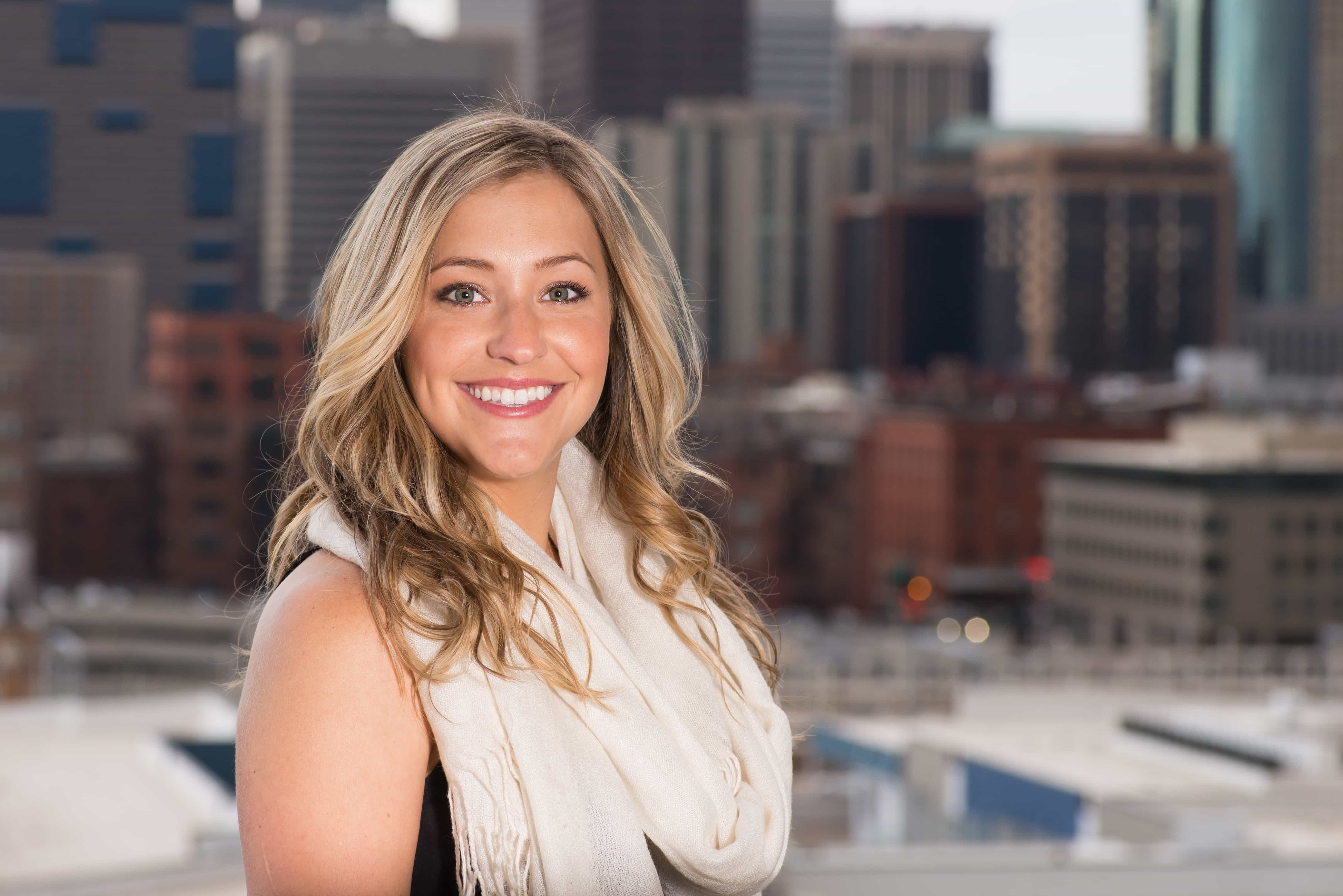 Professional realtor headshot with downtown denver in the background outdoors