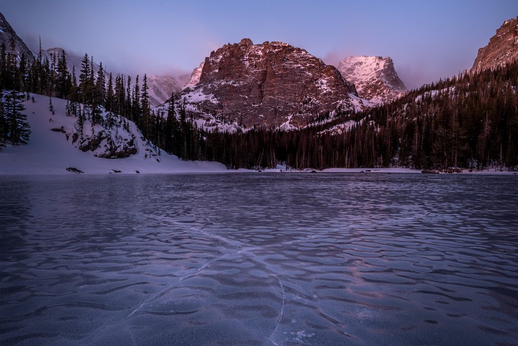 Ice cracks cross at the Loch Vale during winter in Rocky Mountain National Park, Colorado
