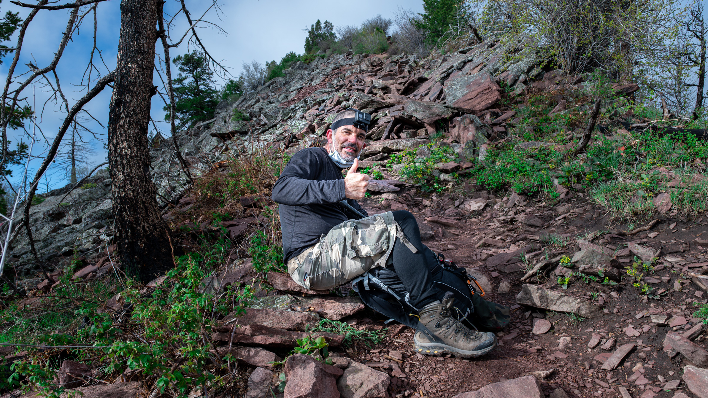 Dave Spates gives a thumbs up, right below Bear Peak, wearing a goPro headmount
