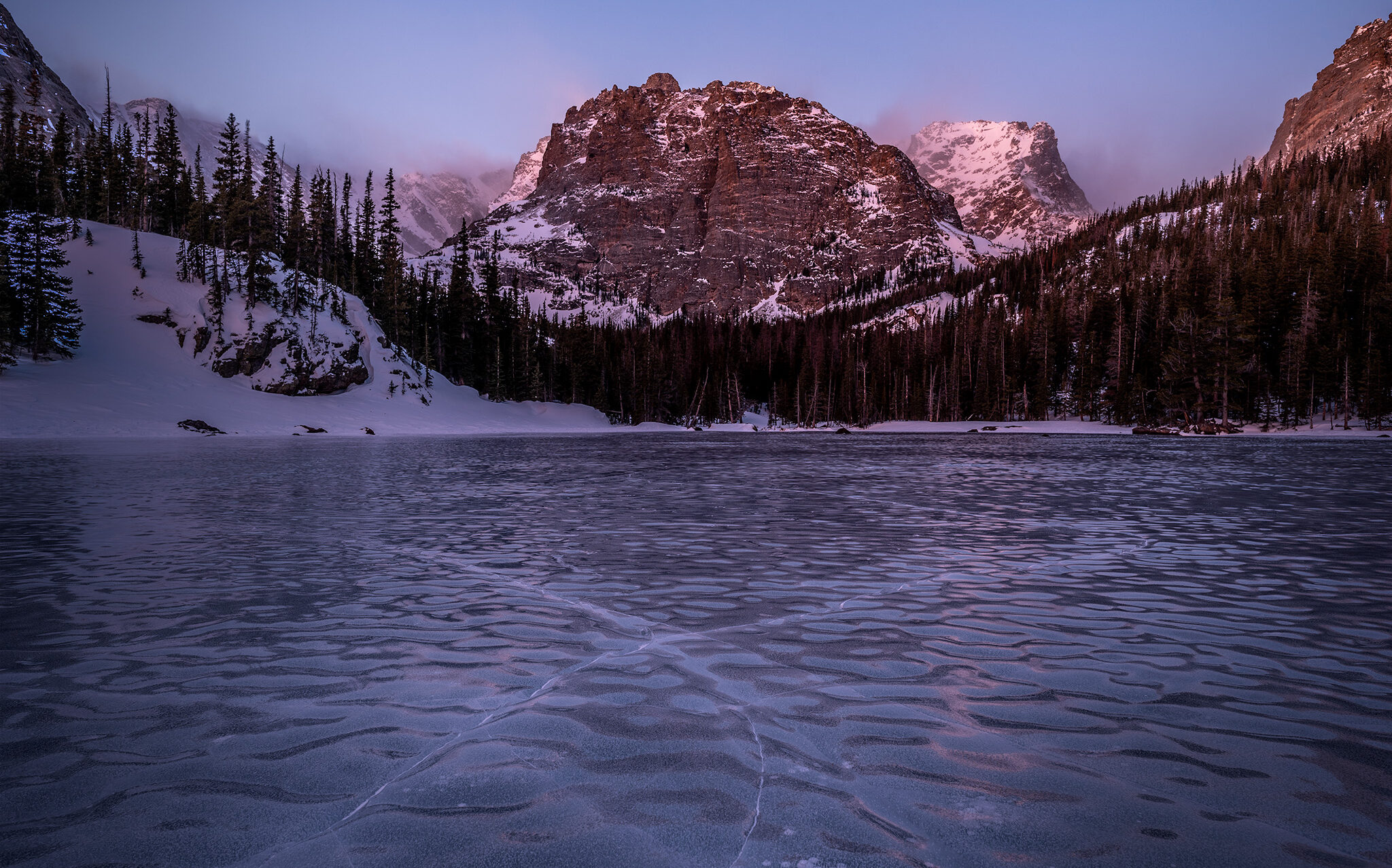 Ice cracks cross at the Loch Vale during winter in Rocky Mountain National Park, Colorado