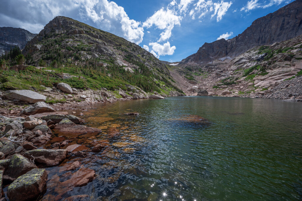 rocky shore of falcon lake and unnamed mountain peak