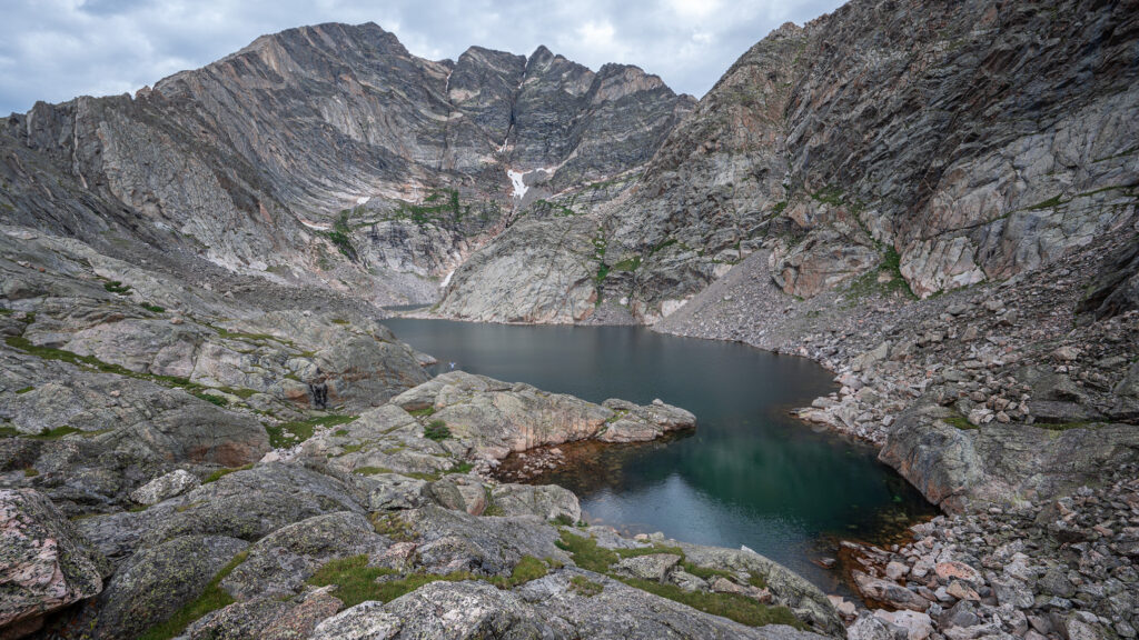 wide view of lower spectacle lake seen from above its rocky shore